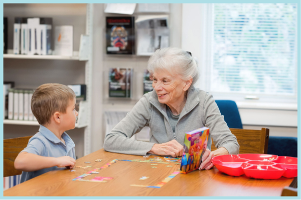 Child and Adult framed.png A photograph of a child and an adult working together on a puzzle.